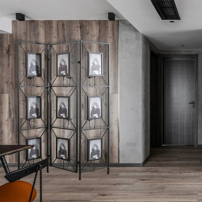 Three-panel black metal room divider with built-in photo frames and geometric lattice on wood wall on Tampa Home & Garden Store