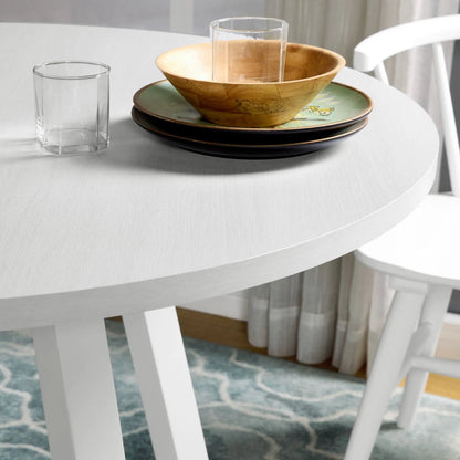 Dining table setting with wooden bowl and glass tumbler atop plates on white trestle table on Tampa Home & Garden Store
