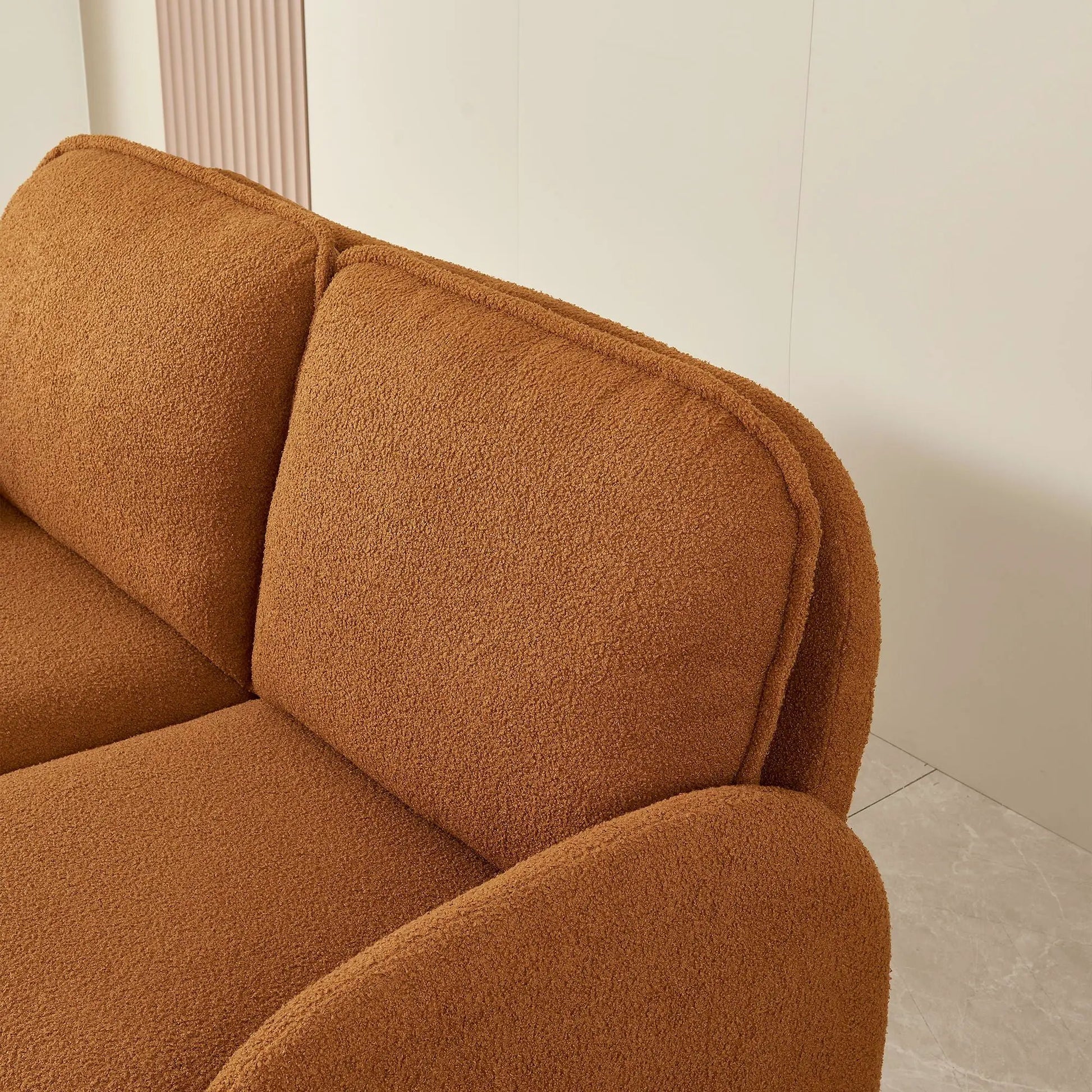 Small sherpa fabric loveseat in warm brown upholstery with plush textured cushions on Tampa Home & Garden Store