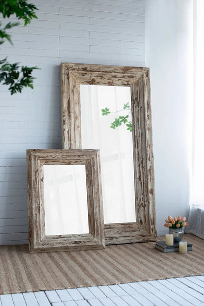 Pair of full-length floor mirrors with distressed brown wood frames leaning against a wall on Tampa Home & Garden Store