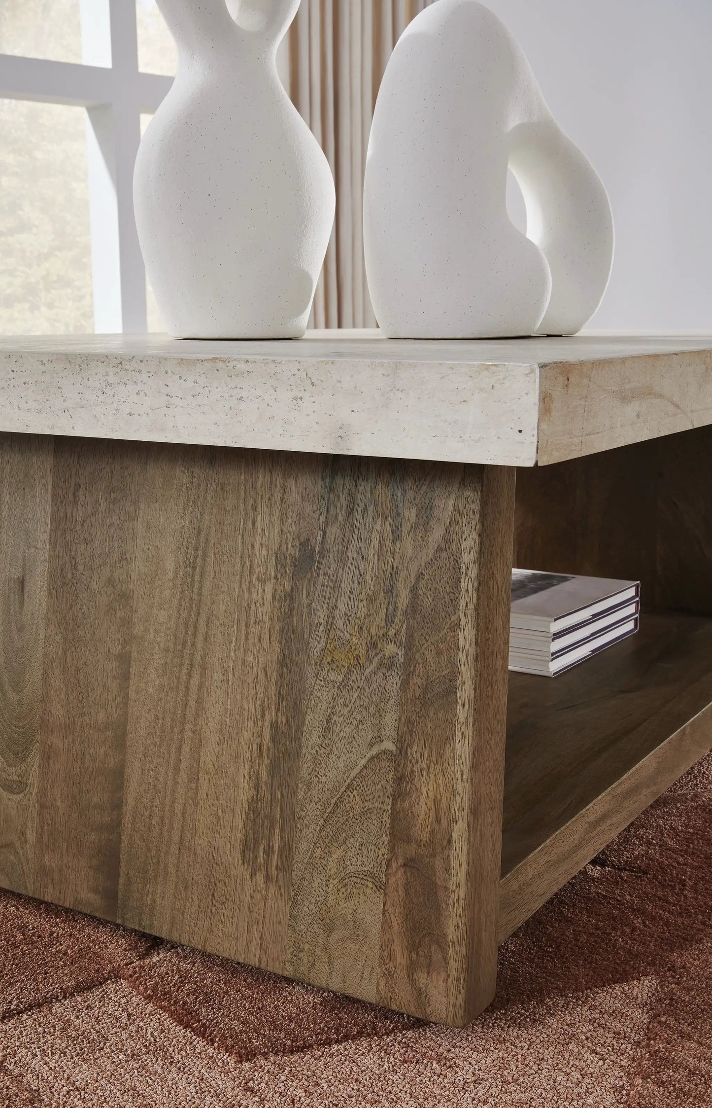 Rectangular cocktail table with light stone top and wood base, two white ceramic vases on Tampa Home & Garden Store