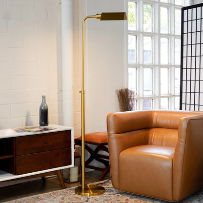 Elara gold floor lamp with curved stem and rectangular shade on Tampa Home & Garden Store