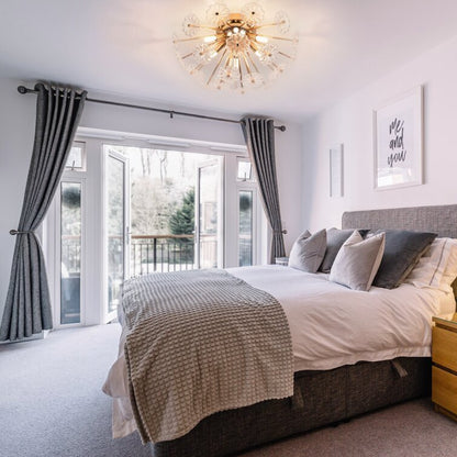 Gold flush mount ceiling light with crystal spokes by HouseOfZazla in a modern bedroom on Tampa Home & Garden Store