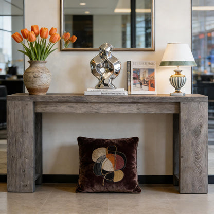 Wood entryway console table with weathered gray finish, orange tulip vase, chrome sculpture, and lamp on Tampa Home & Garden Store