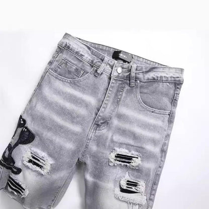 Men's gray denim jeans by FLIPSTYLEZLLC with cobra embroidery and ripped patches on Tampa Home & Garden Store