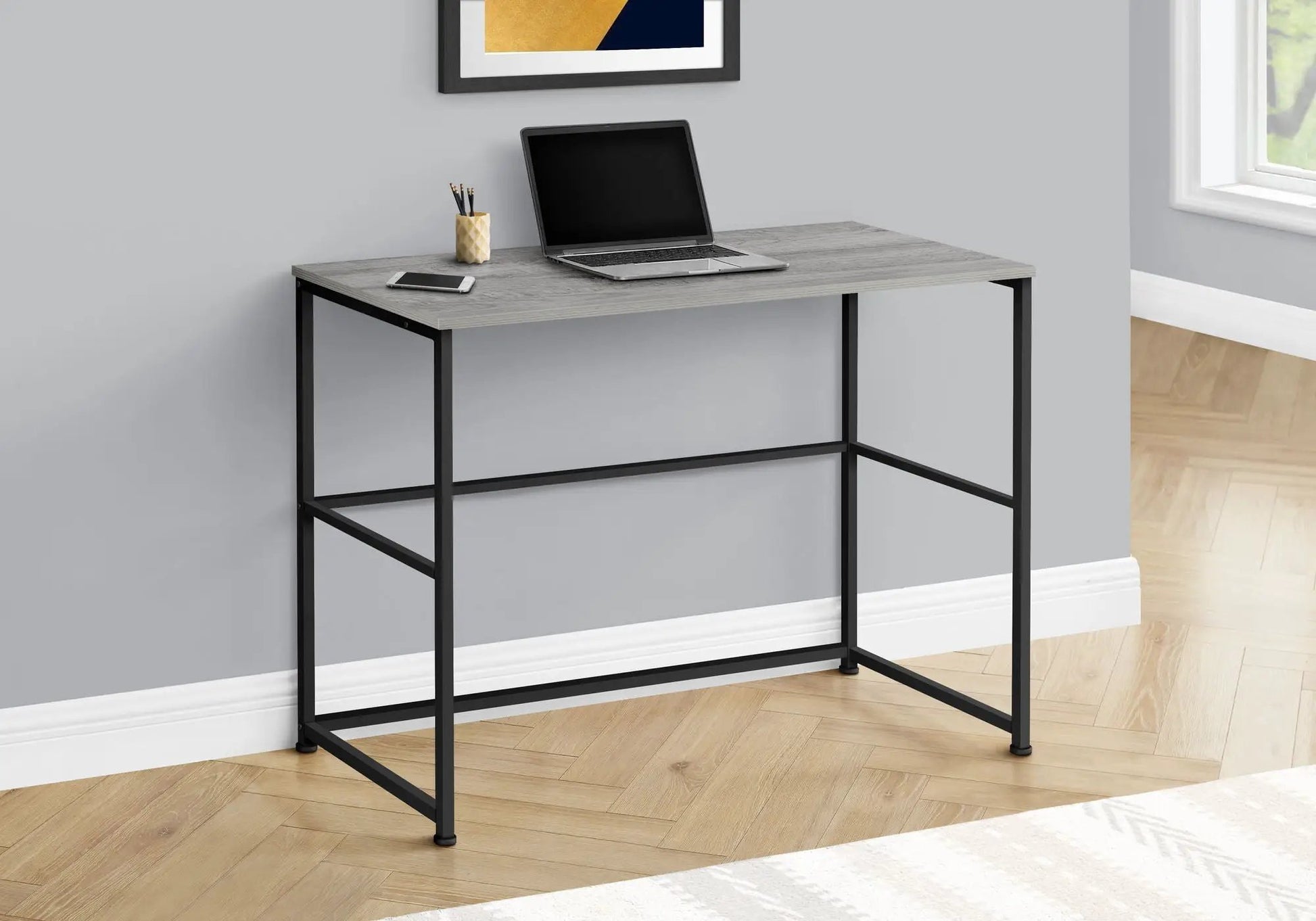 Computer desk gray wood top with black metal frame, laptop and phone on Tampa Home & Garden Store