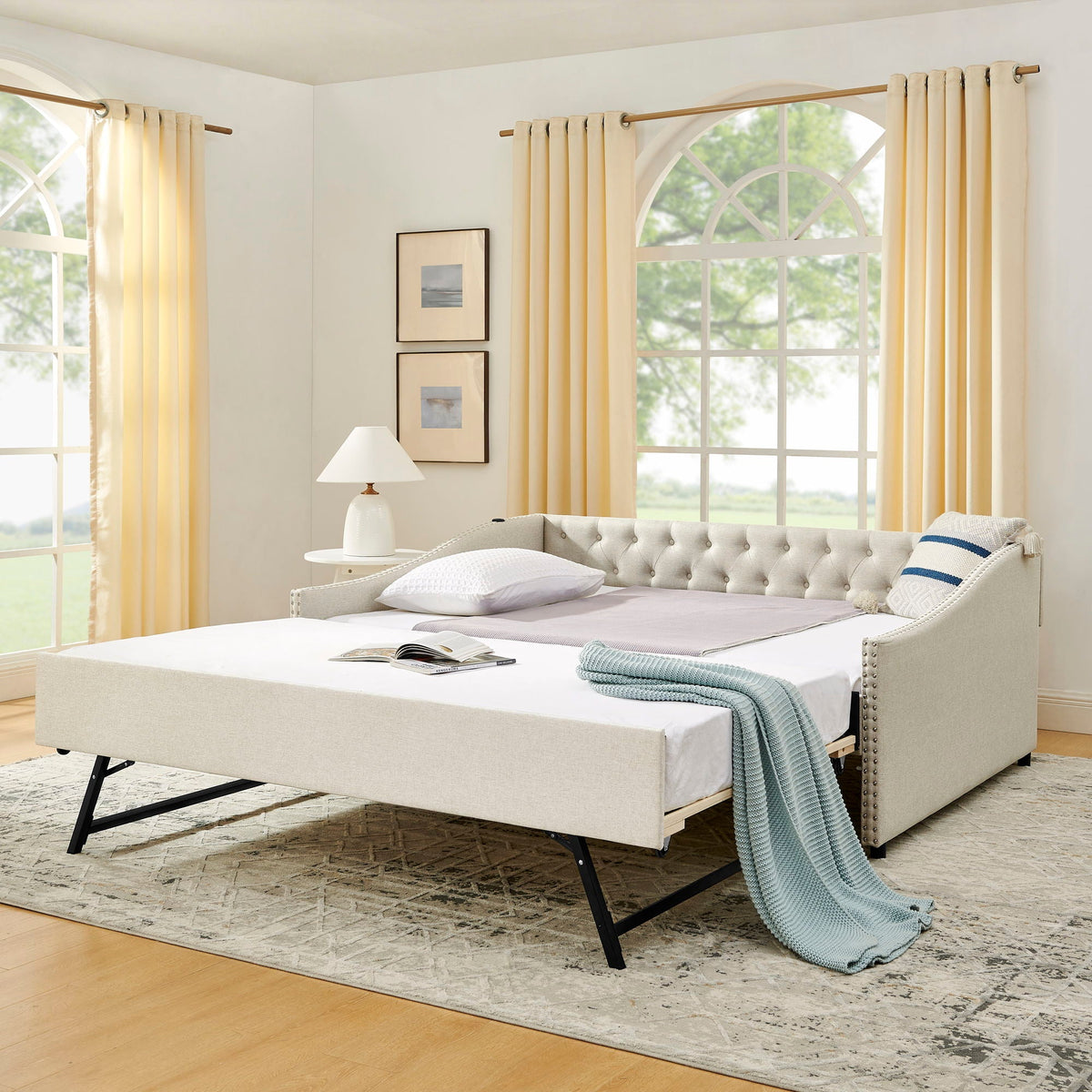 Upholstered daybed with pull-out trundle in beige fabric, tufted back and black metal legs on Tampa Home & Garden Store