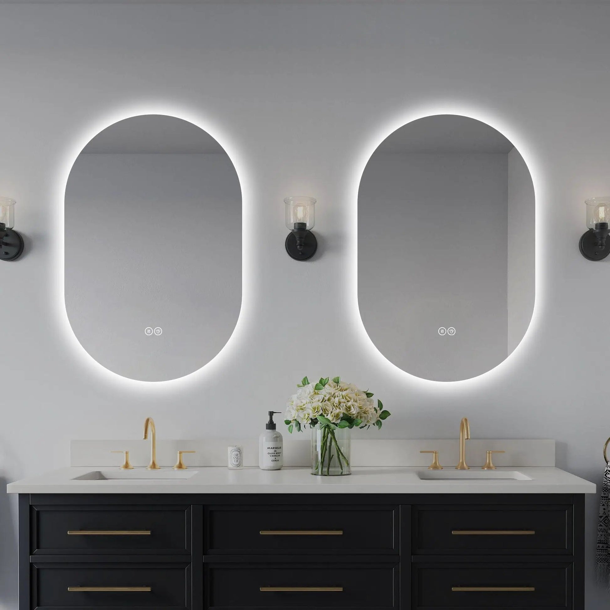 Smart oval LED wall mirror with anti-fog and adjustable lighting; mirrors above white countertop on Tampa Home & Garden Store