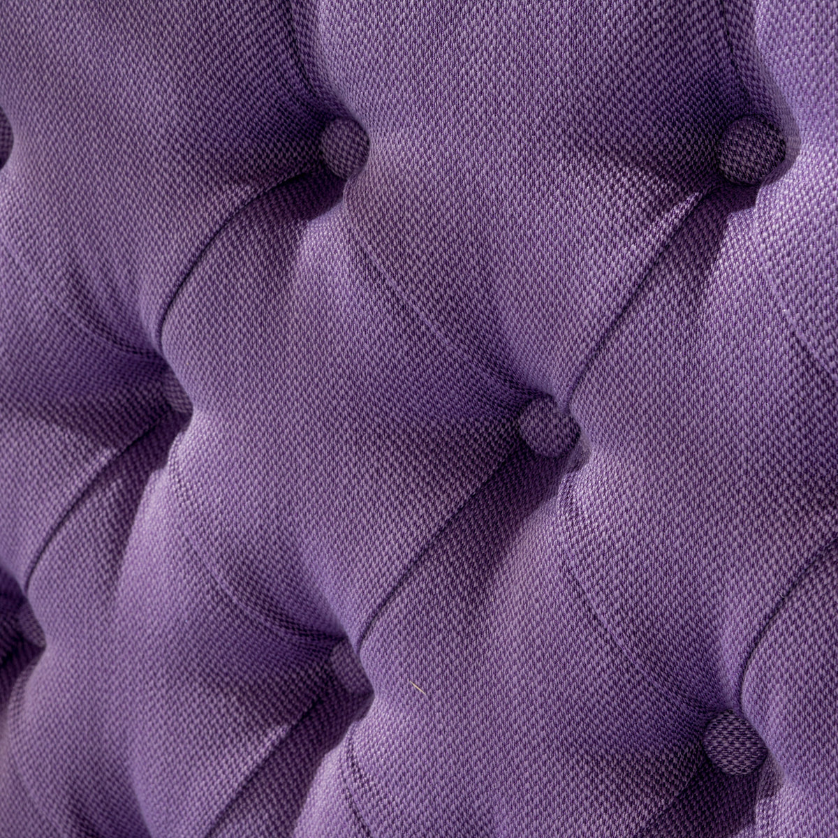 Purple tufted upholstery fabric close-up with textured weave on Tampa Home & Garden Store
