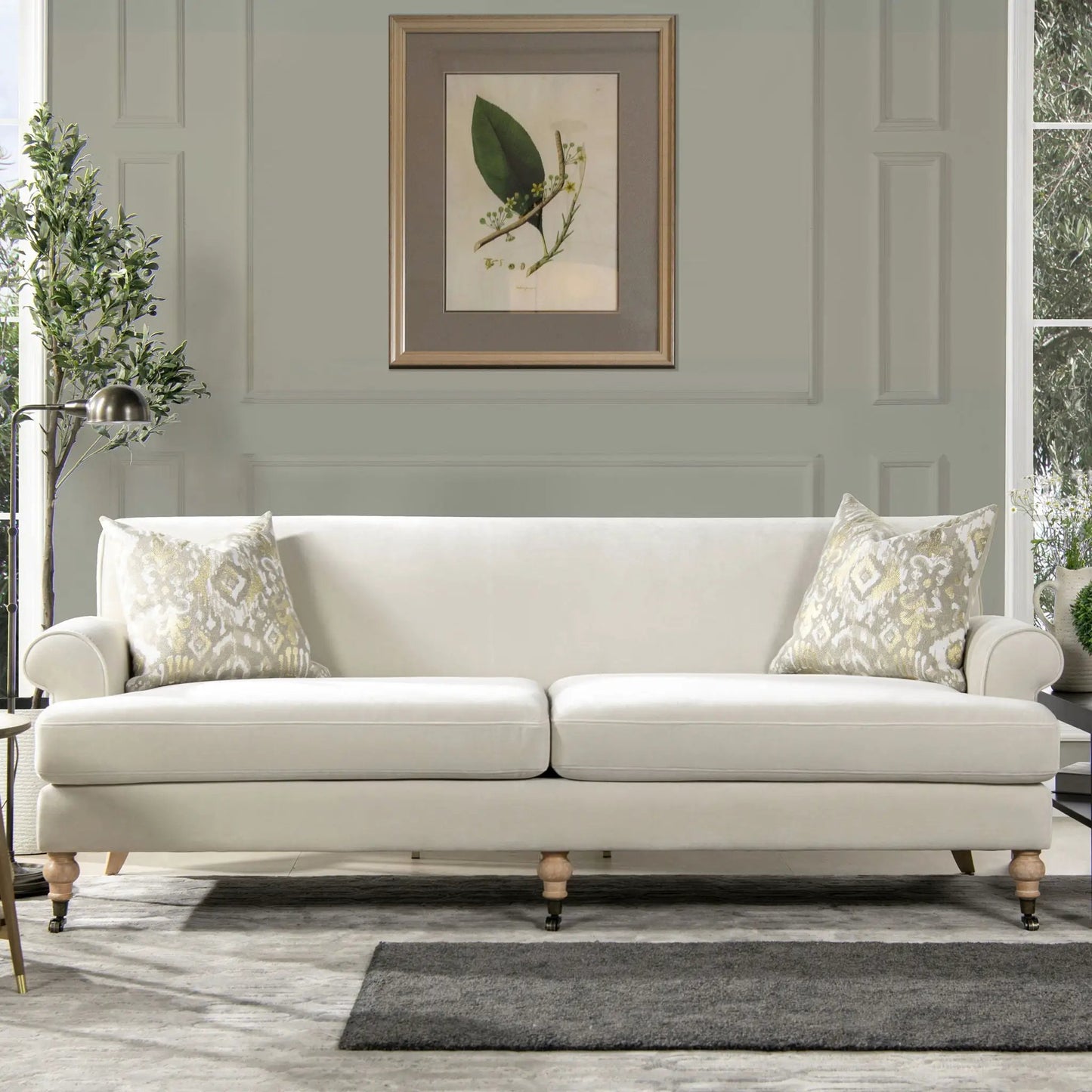 Alana Lawson Two Cushion Tightback Sofa cream upholstery with wooden bun feet on Tampa Home & Garden Store