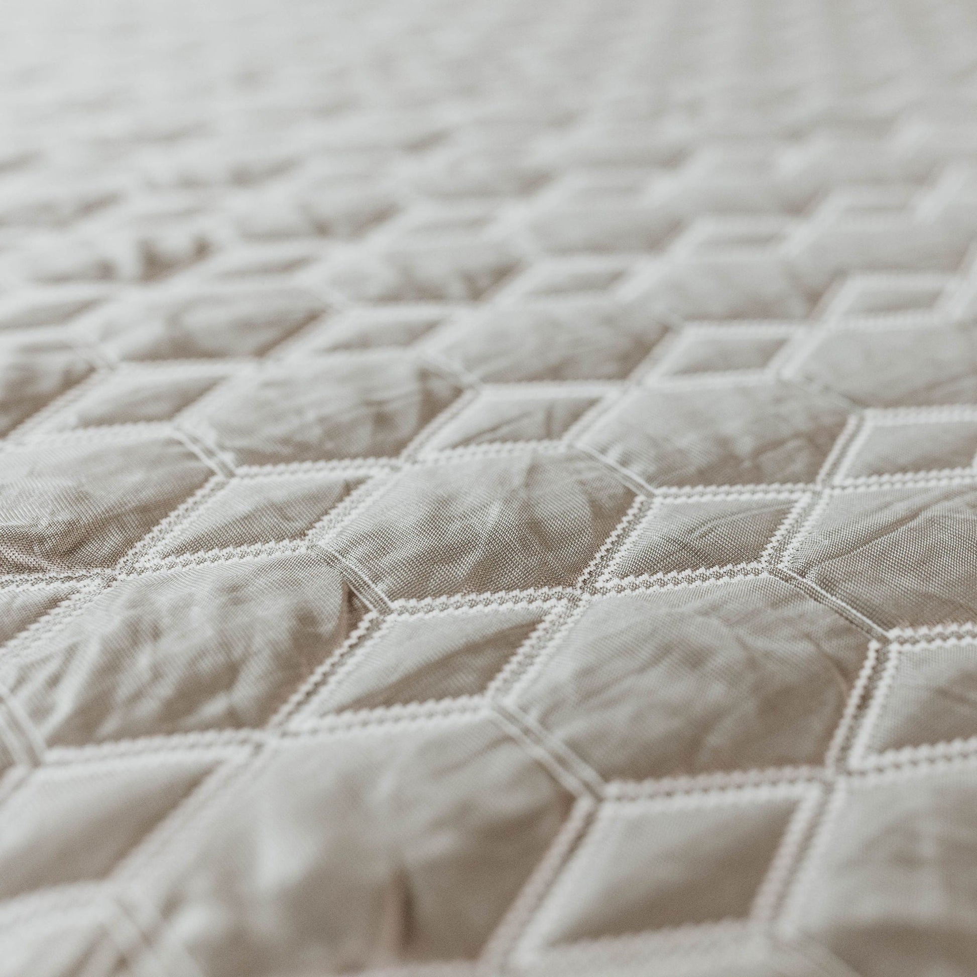 Copper Lux Hybrid 14in mattress fabric closeup shows beige striped quilted cover on Tampa Home & Garden Store
