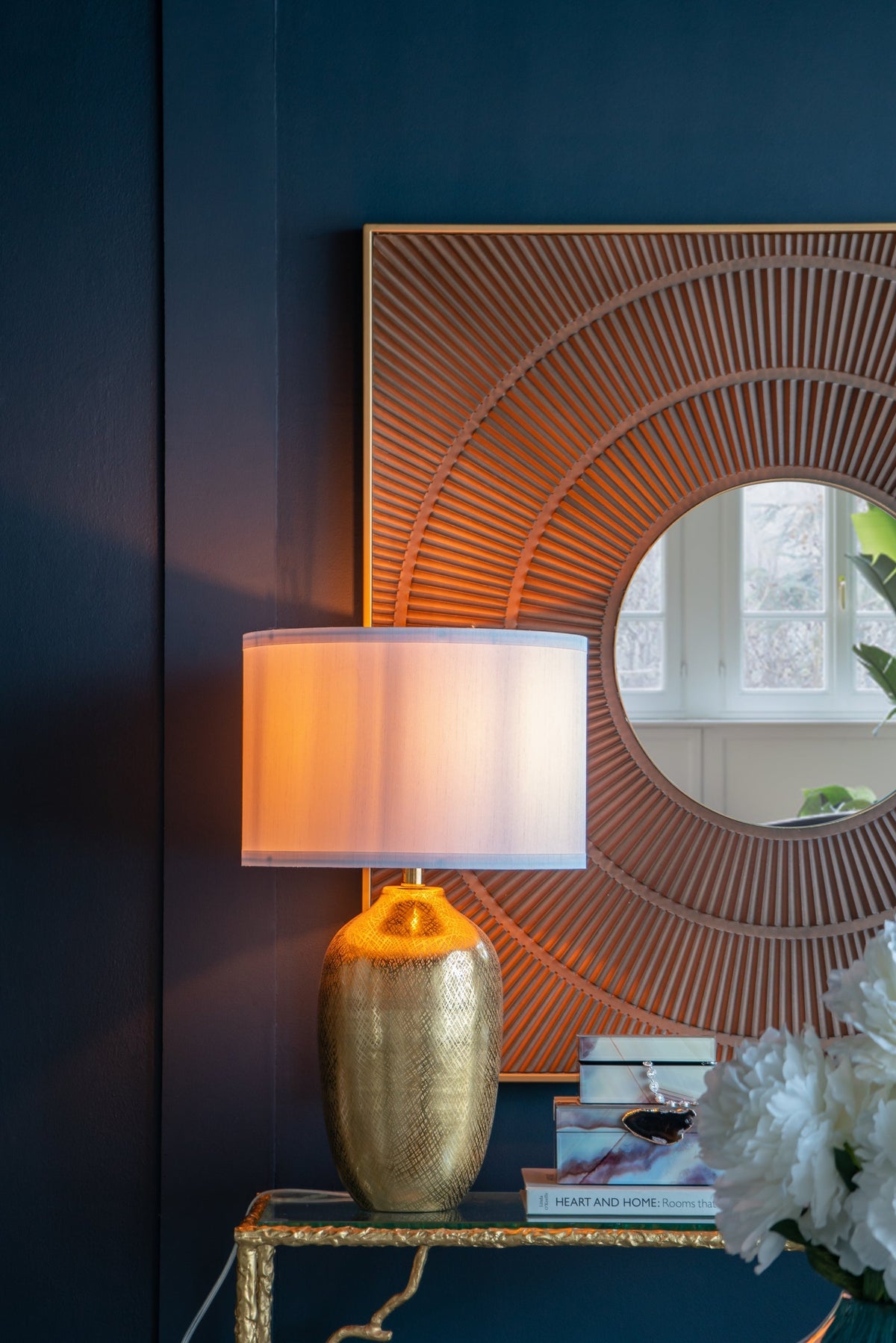 D18x31in round aluminum gold lamp with white shade beside sunburst mirror on wall on Tampa Home & Garden Store