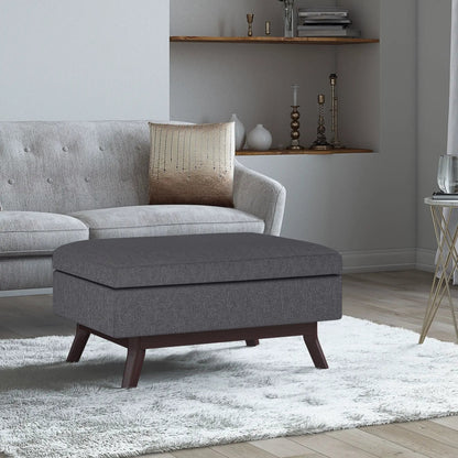 Owen upholstered rectangular storage ottoman in gray fabric with dark wood legs on Tampa Home & Garden Store