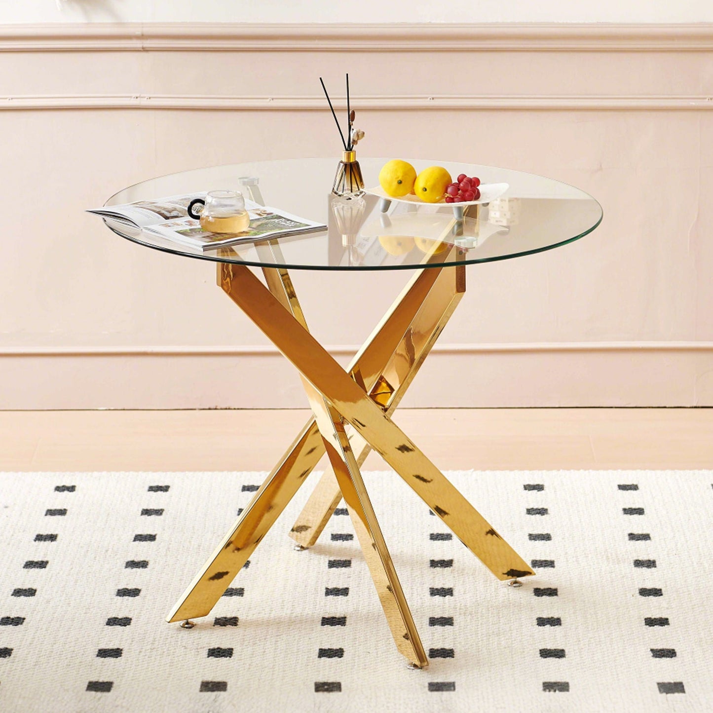 Dining Table by HouseOfZazla with round glass top and gold crisscross legs on Tampa Home & Garden Store