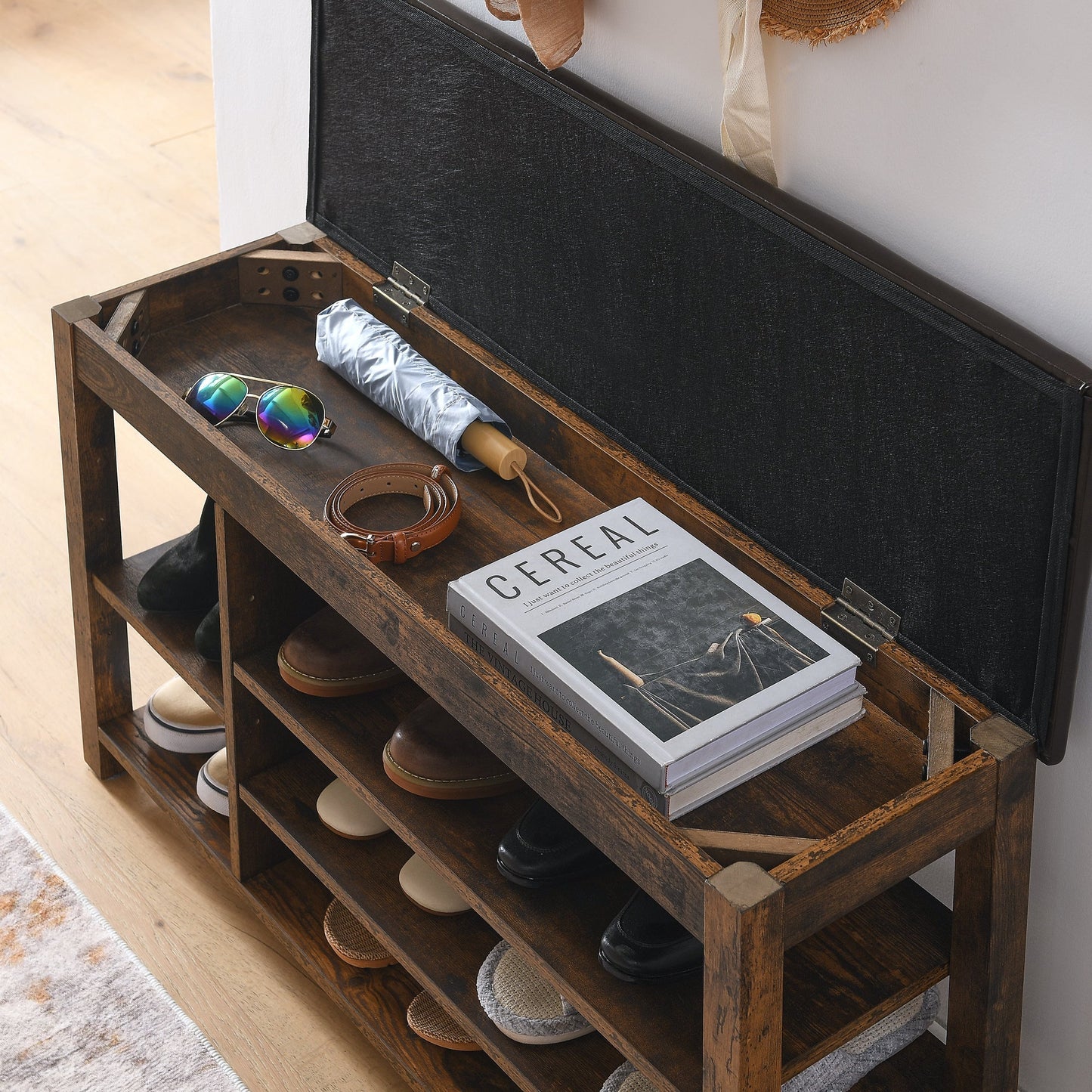 Height-Adjustable shoe-changing bench in dark wood with open storage shelves and shoes on Tampa Home & Garden Store