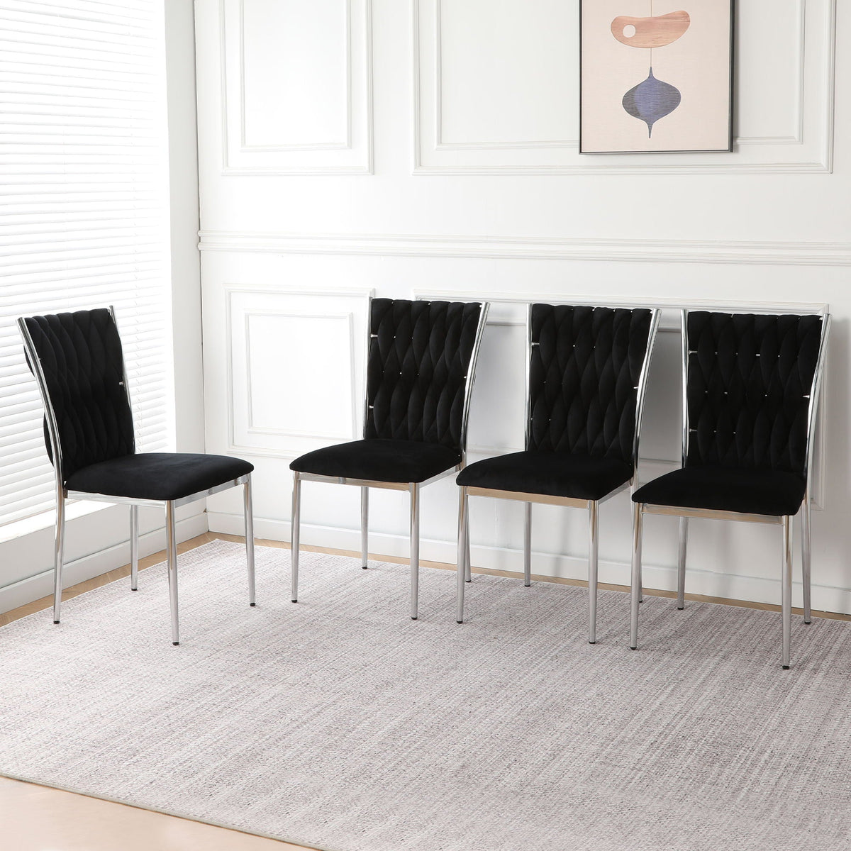 Five black tufted fabric dining chairs with chrome metal legs along a white paneled wall on Tampa Home & Garden Store
