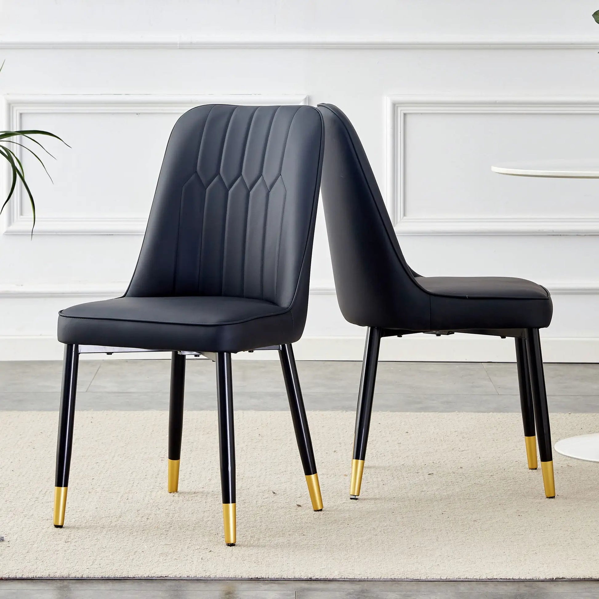 Modern chair set: two black upholstered chairs with channel quilting and gold-tipped metal legs on Tampa Home & Garden Store