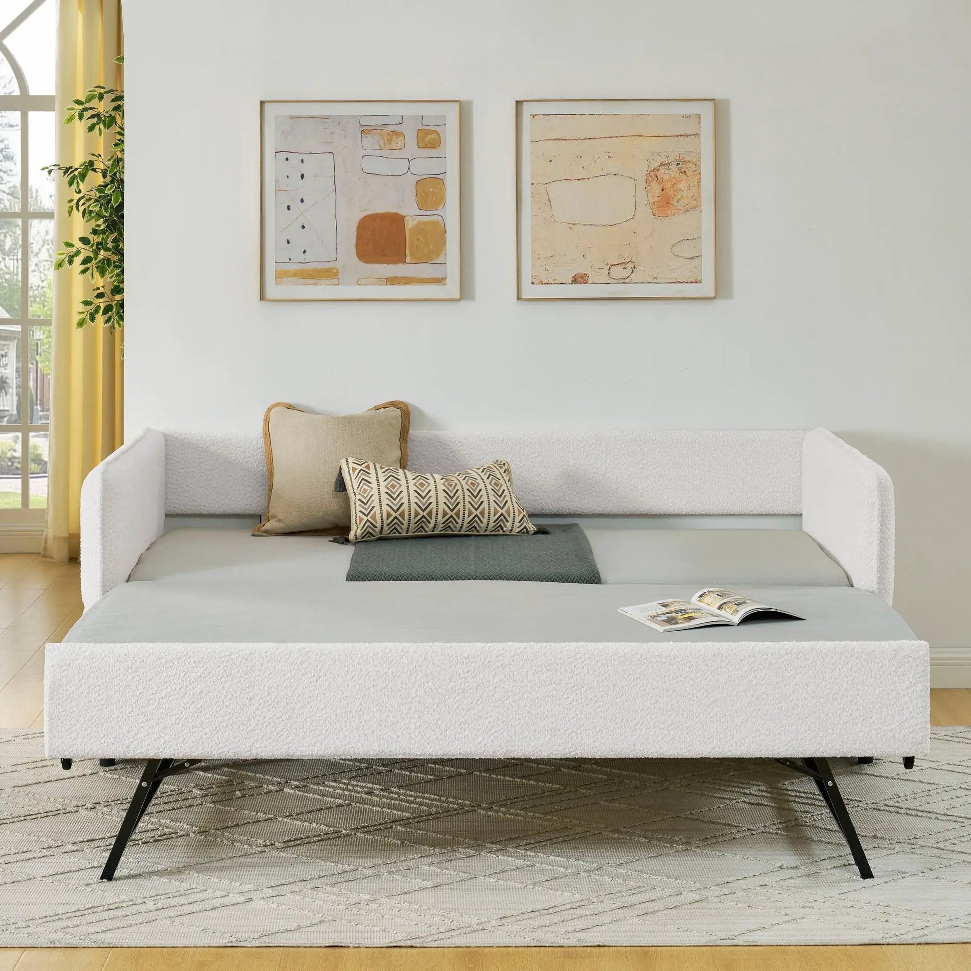 Upholstered daybed with pop-up trundle in white frame, light gray mattress on Tampa Home & Garden Store