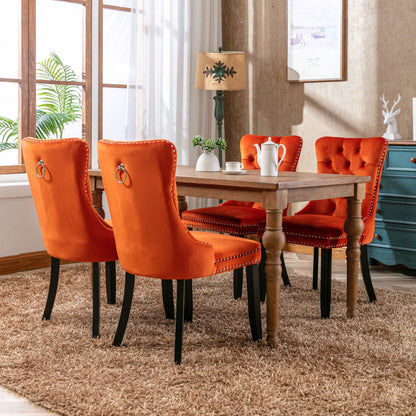 Tufted velvet dining chair set in orange with nailhead trim, 4 chairs around a wooden table on Tampa Home & Garden Store