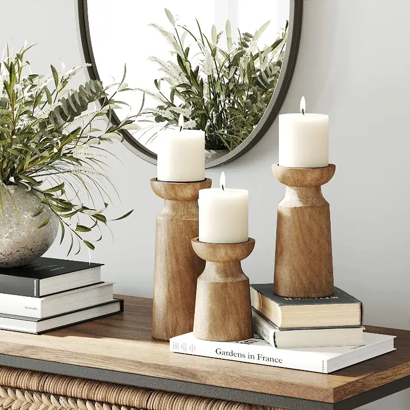 Solid wood retro candlestick set with 3 heights and white pillar candles atop a wooden table on Tampa Home & Garden Store