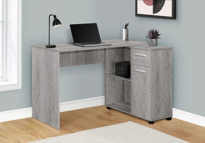 L-shaped corner desk in grey wood finish with drawers, open cubby, laptop, lamp and plant on Tampa Home & Garden Store