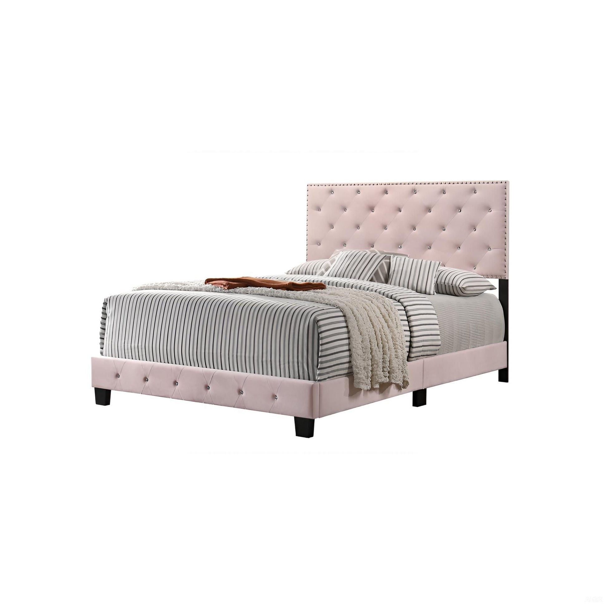 Luxurious upholstered bed with blush pink tufted headboard and striped gray bedding on Tampa Home & Garden Store
