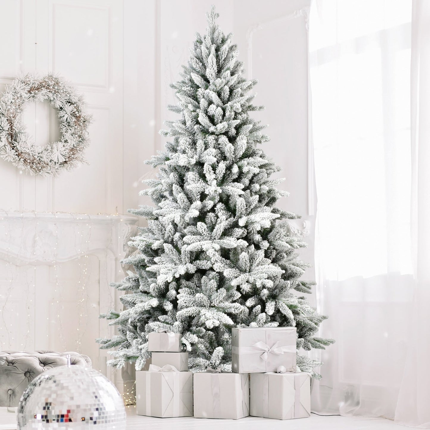 7ft flocked Christmas tree with 1514 tips, snowy branches beside wrapped gifts in a bright room on Tampa Home & Garden Store
