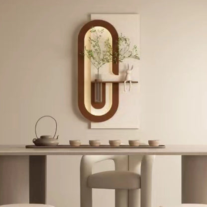 Wall decor with oval wood frames in coffee tones, faux greenery in a glass vase on Tampa Home & Garden Store
