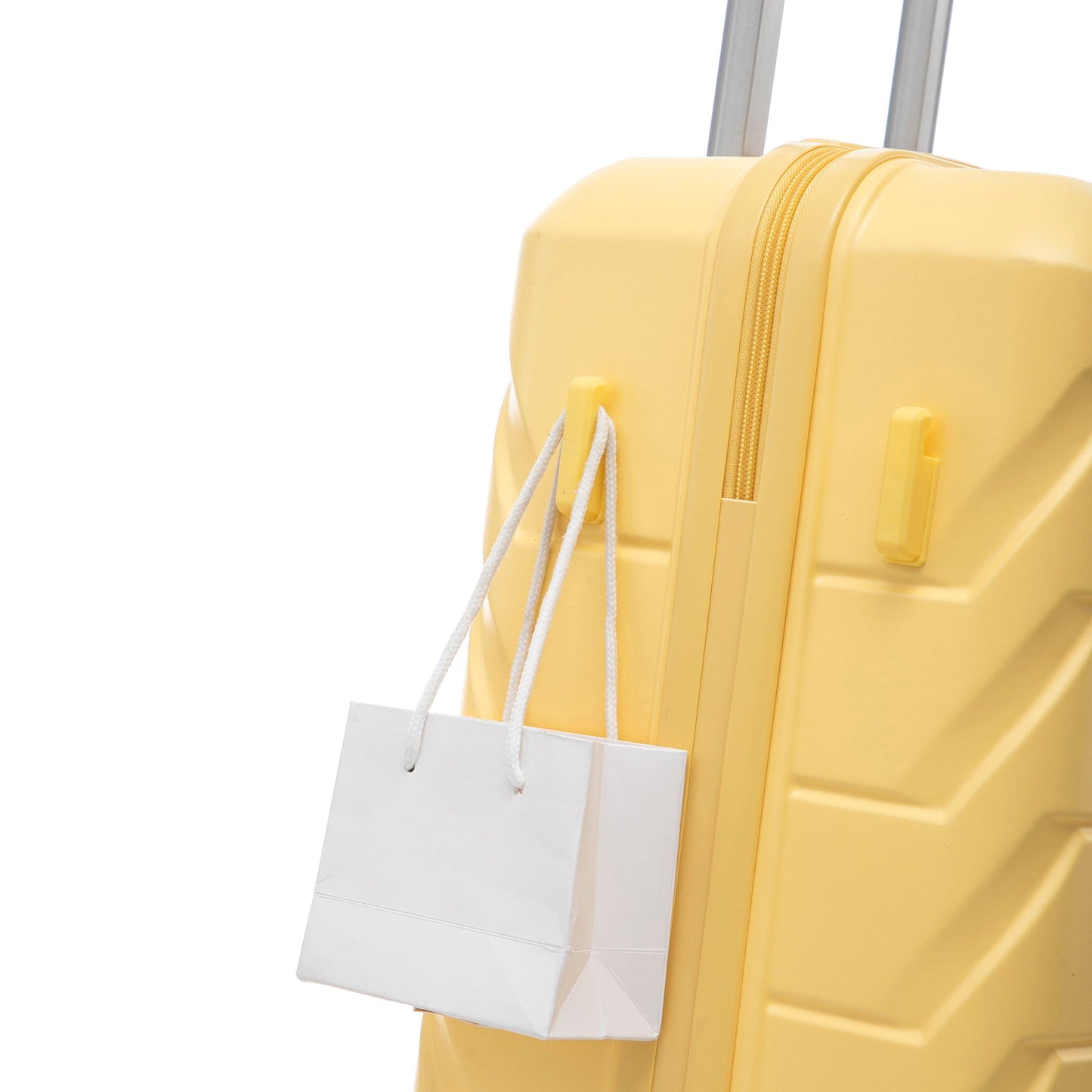 Yellow spinner luggage close-up with a white shopping bag hanging from the handle on Tampa Home & Garden Store