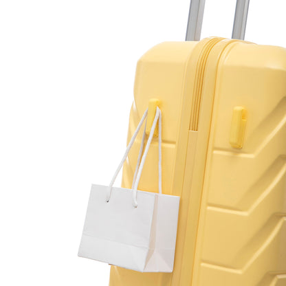 Yellow spinner luggage close-up with a white shopping bag hanging from the handle on Tampa Home & Garden Store