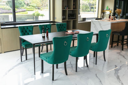 Six teal velvet tufted dining chairs with nailhead trim and ring pulls around a dark table on Tampa Home & Garden Store
