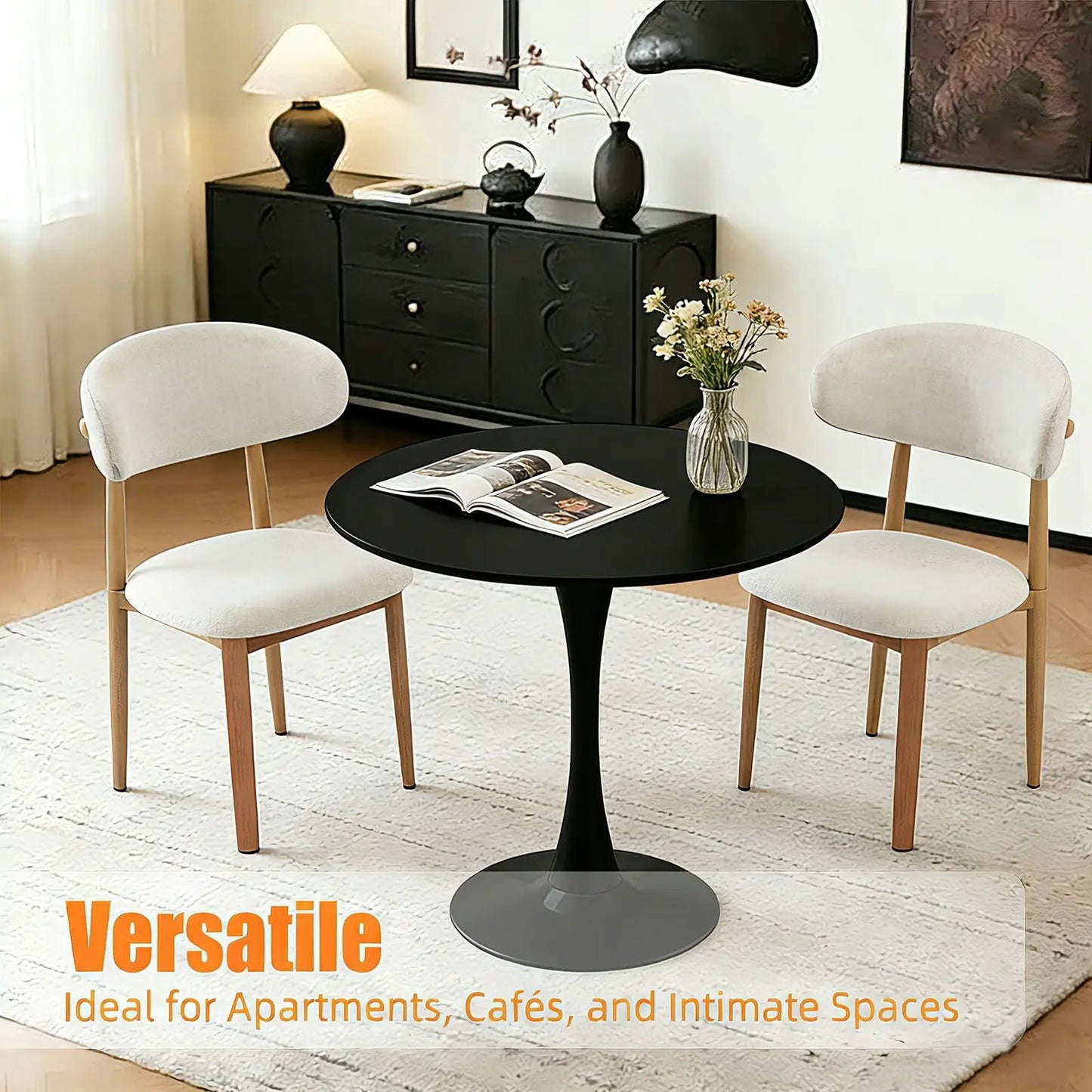 Round dining table with tulip-style black pedestal base, 4 cream upholstered chairs on Tampa Home & Garden Store