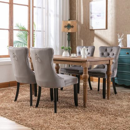 Tufted velvet dining chairs with nailhead trim, gray upholstery, 4 chairs around a wood table on Tampa Home & Garden Store