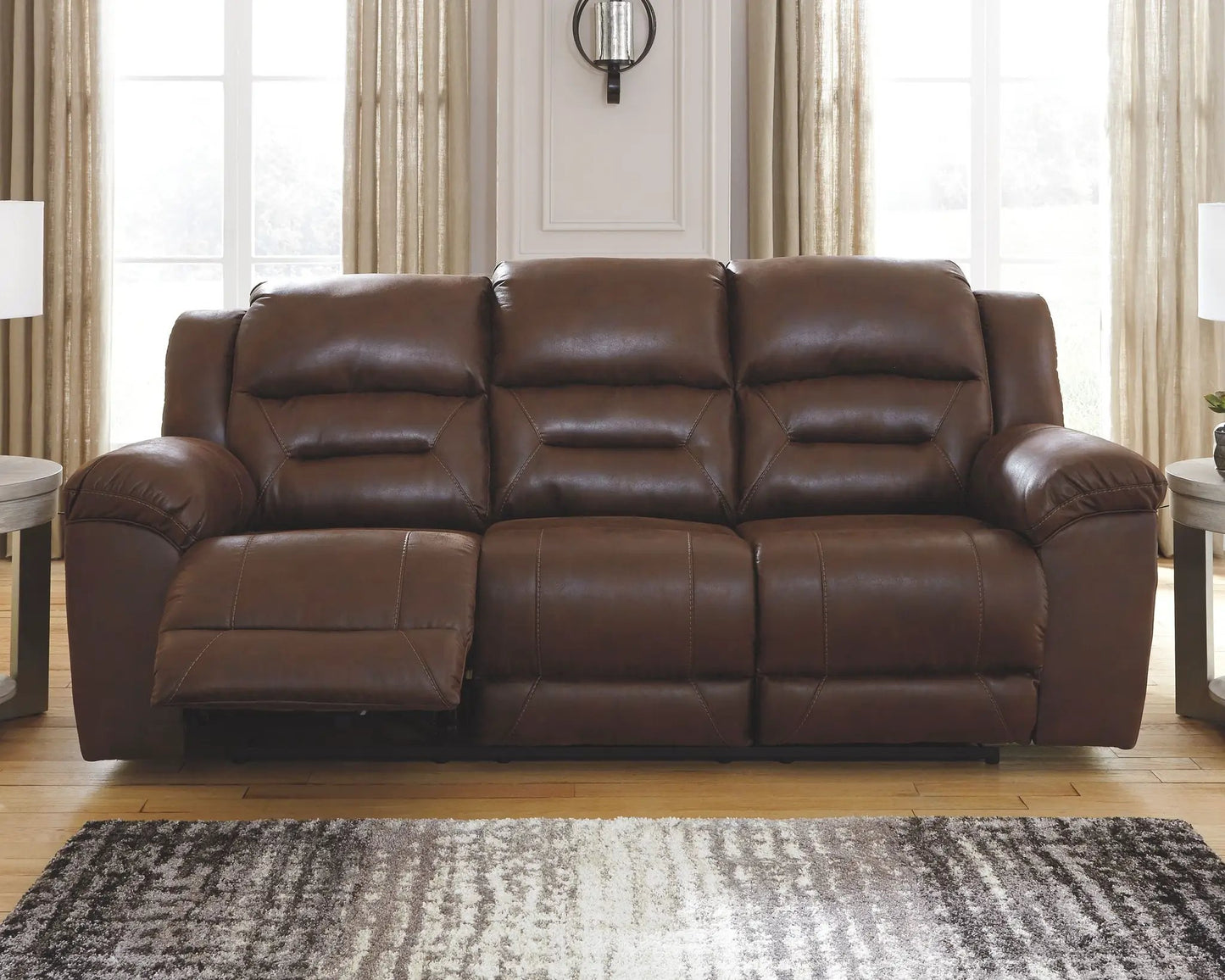 Stoneland Power Reclining Sofa dark brown leather with tufted cushions in living room on Tampa Home & Garden Store