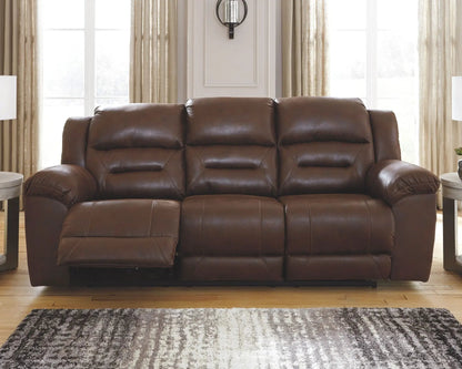 Stoneland Power Reclining Sofa dark brown leather with tufted cushions in living room on Tampa Home & Garden Store