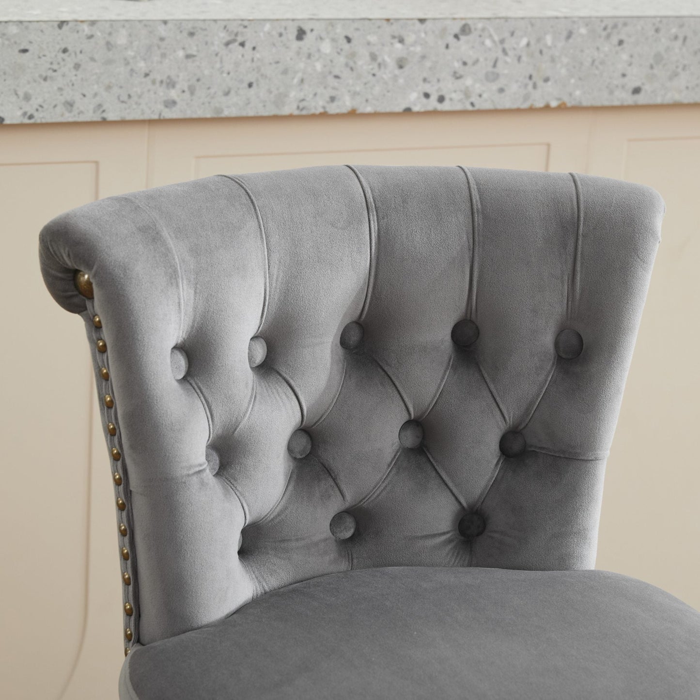 Gray velvet tufted chair with buttoned back and brass nailhead trim on Tampa Home & Garden Store