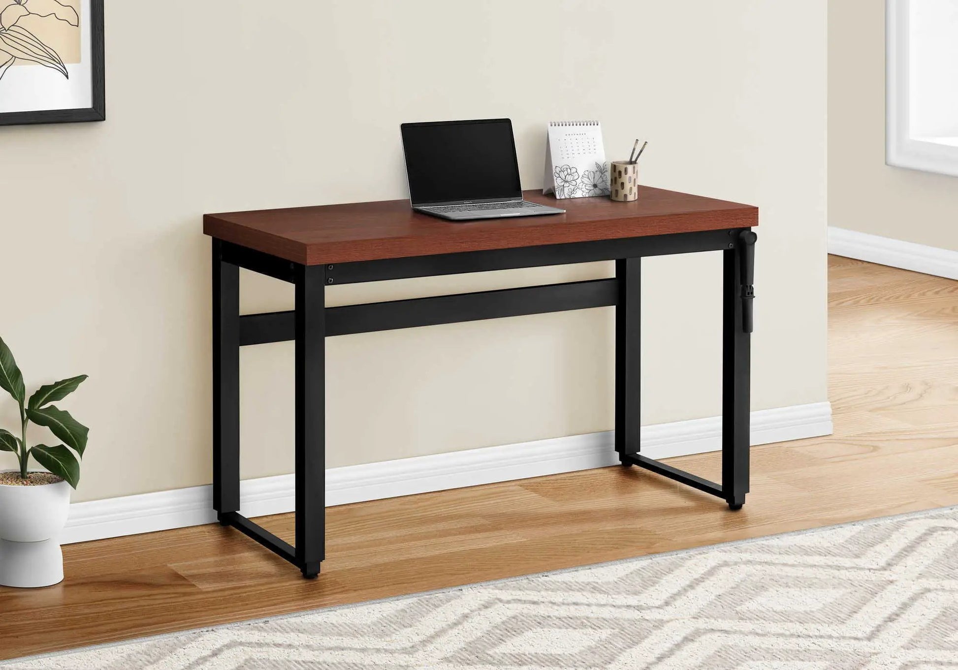 Standing computer desk with warm wood top and black metal frame, laptop on desk on Tampa Home & Garden Store