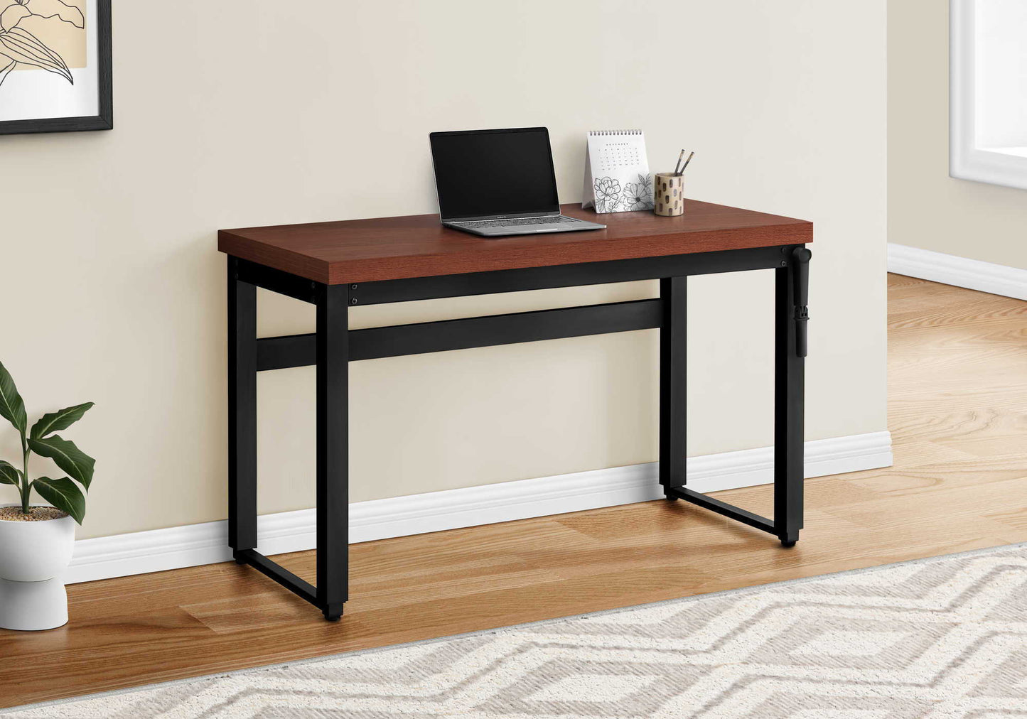Adjustable standing computer desk with dark wood top and black metal frame, laptop on desk on Tampa Home & Garden Store