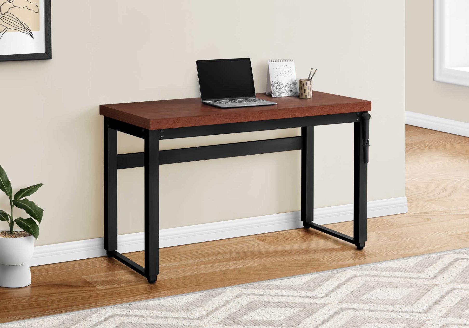 Adjustable standing computer desk with dark wood top and black metal frame, laptop on desk on Tampa Home & Garden Store