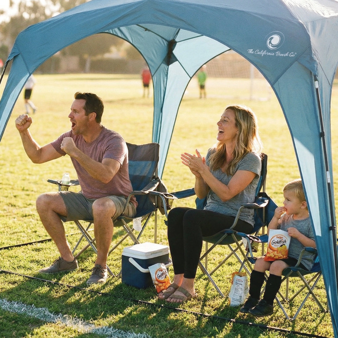 Pop 'N Go Canopy blue shelter with three people in camping chairs, cooler and snacks on Tampa Home & Garden Store