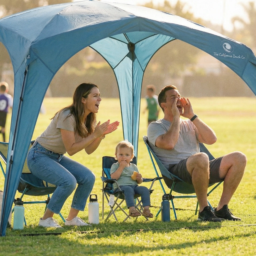 Pop 'N Go Canopy blue portable outdoor canopy with The California Beach Co logo; family of three under shade on Tampa Home & Garden Store