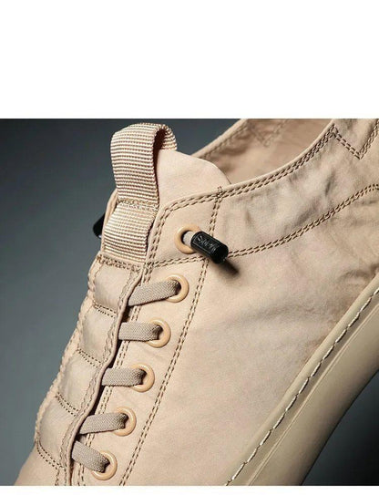 Beige canvas men's sneakers with lace-up closure and back pull tab for casual wear on Tampa Home & Garden Store