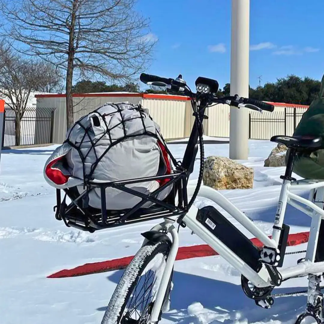 Basket Black front bicycle cargo basket with gray bag secured by bungee on a white e-bike on Tampa Home & Garden Store