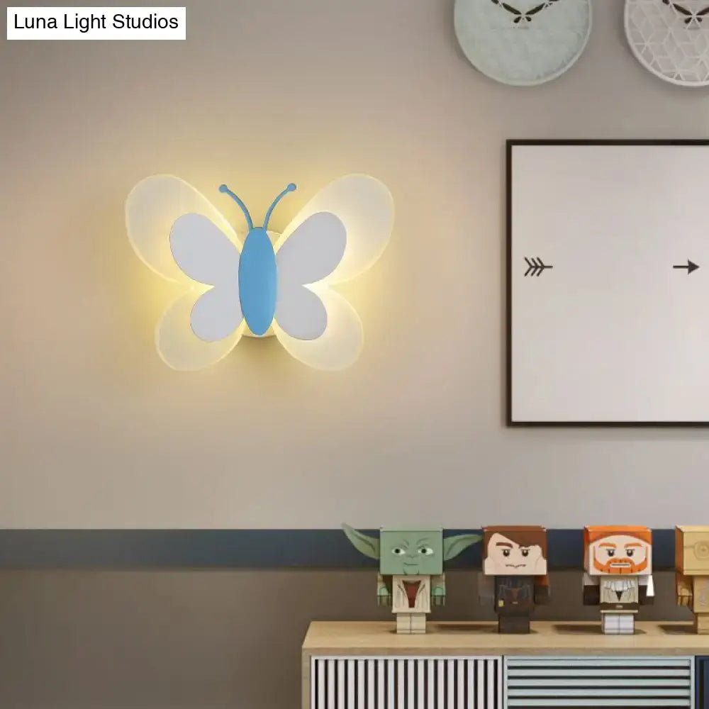 Butterfly LED Wall Light by Decorbites; blue body, white wings, warm ambient glow on wall on Tampa Home & Garden Store