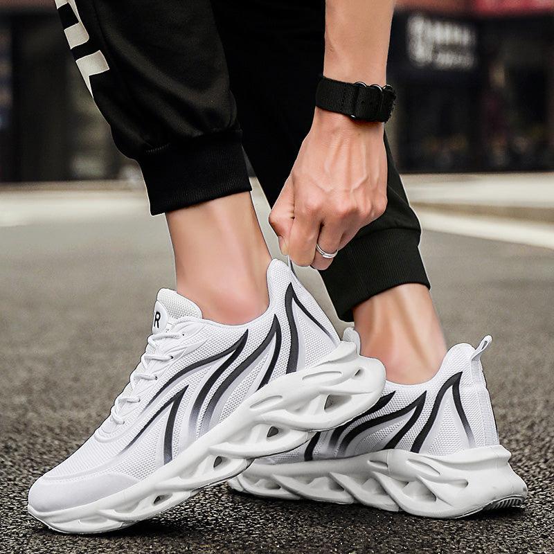 Pair of Stevvex white athletic sneakers with black flame accents, breathable running shoes on Tampa Home & Garden Store