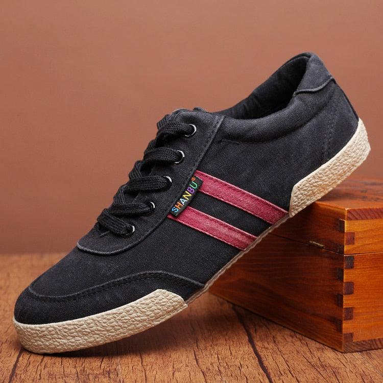 Stevvex black canvas sneakers with red side stripes, lace-up, beige textured sole on Tampa Home & Garden Store