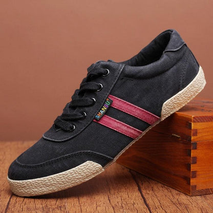 Stevvex black canvas sneakers with red side stripes, lace-up, beige textured sole on Tampa Home & Garden Store