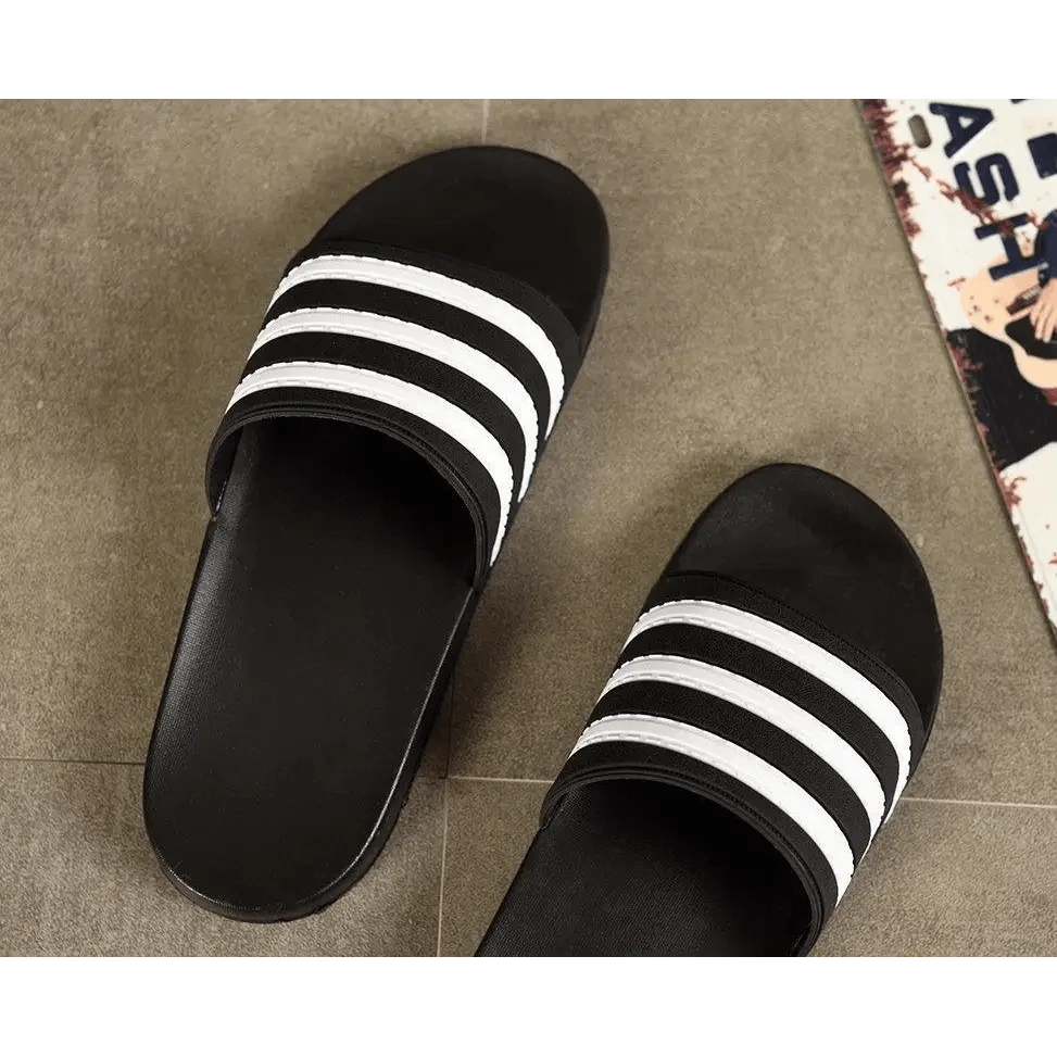 Stevvex black slide sandals with white striped straps, casual summer outdoor footwear pair on Tampa Home & Garden Store