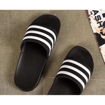 Stevvex black slide sandals with white striped straps, casual summer outdoor footwear pair on Tampa Home & Garden Store