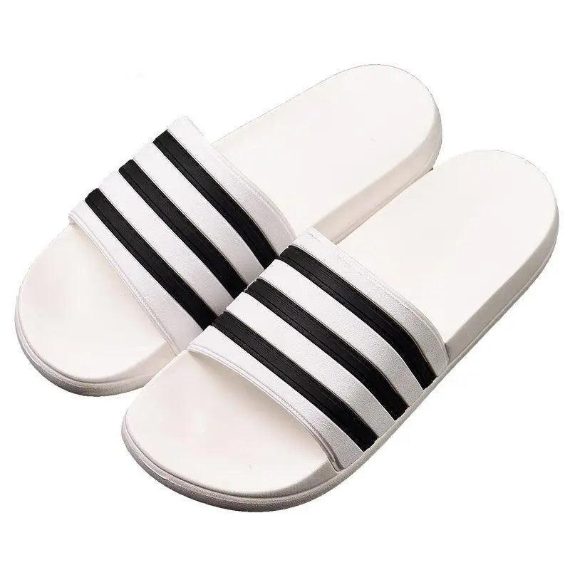 White slide sandals by Stevvex with black striped bands, casual summer outdoor footwear on Tampa Home & Garden Store